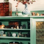 Bedroom cabinetry with ornate brass panel insets