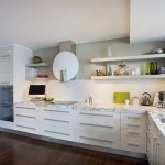 Fitted kitchen with ornate stone bench tops and glass splash backs