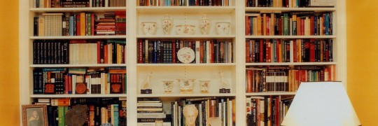 Bookcase with broken pediment is built for a room for technology