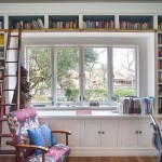 Home office cabinetry with built in bookshelves and library ladder